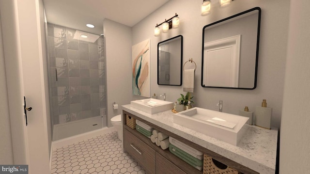 bathroom featuring vanity, tile patterned flooring, toilet, and a tile shower