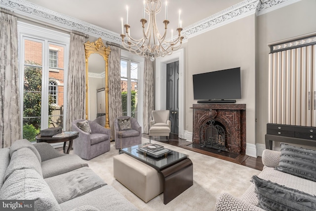 living room featuring ornamental molding, light wood-type flooring, and an inviting chandelier