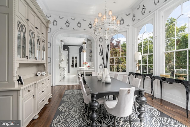 dining room featuring ornamental molding, a chandelier, and dark hardwood / wood-style flooring