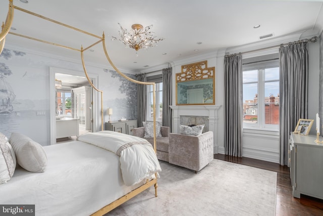 bedroom with ornamental molding and wood-type flooring