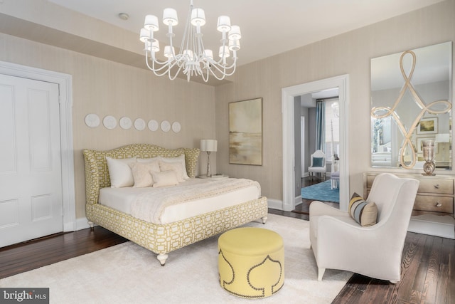 bedroom featuring an inviting chandelier and wood-type flooring