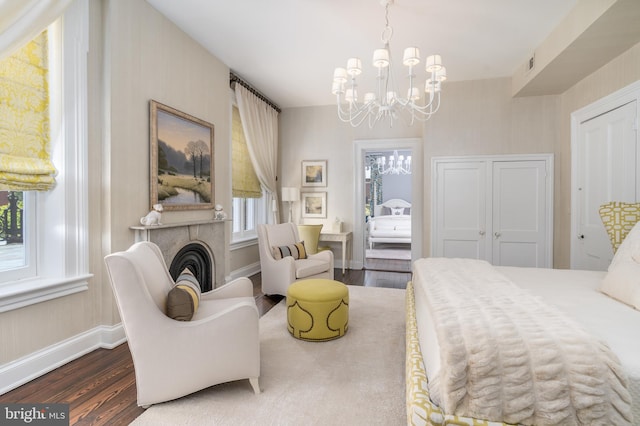 bedroom with dark wood-type flooring and a chandelier