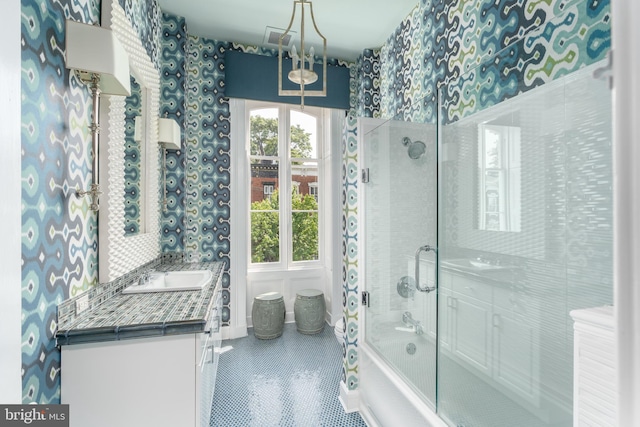 bathroom with enclosed tub / shower combo, vanity, and tile patterned floors