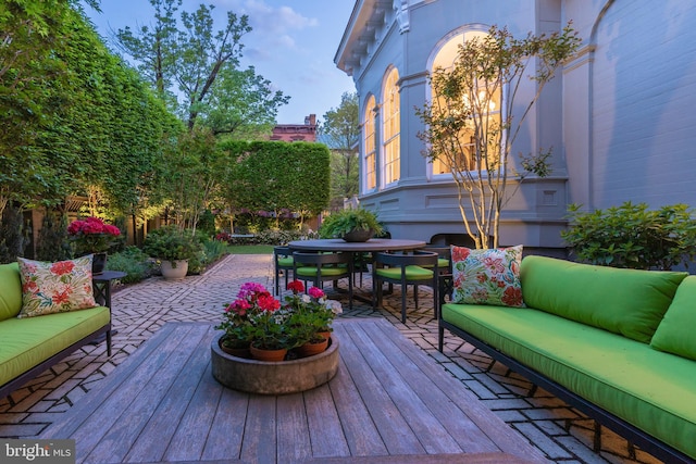 wooden terrace with outdoor lounge area and a patio