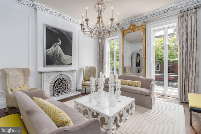 living room featuring plenty of natural light, a chandelier, and light hardwood / wood-style flooring