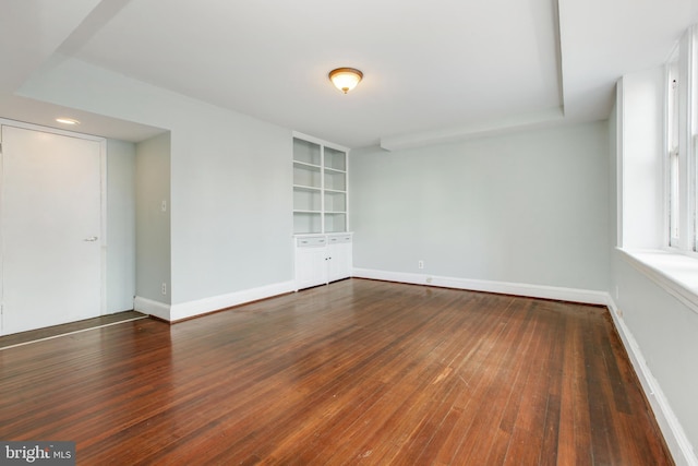 spare room featuring dark wood-type flooring