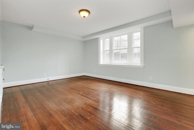 spare room featuring dark wood-type flooring