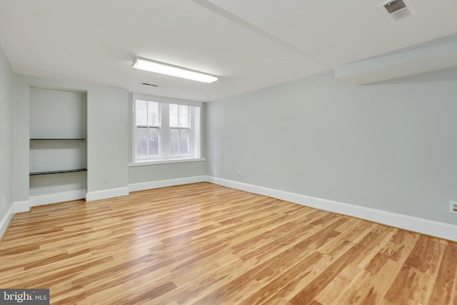 basement with light hardwood / wood-style floors