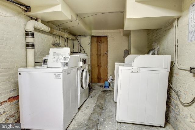 clothes washing area with washer and dryer