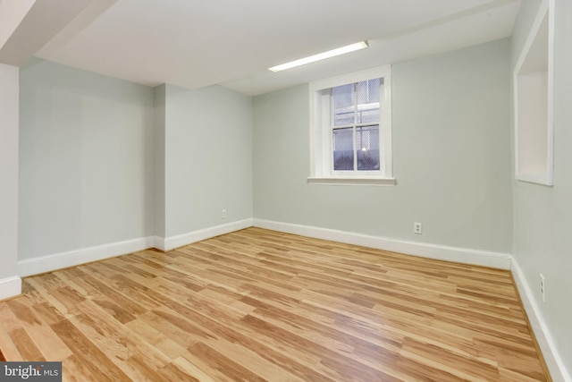 empty room with light hardwood / wood-style flooring