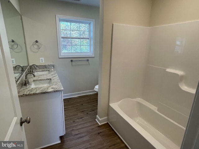 full bathroom with vanity, hardwood / wood-style flooring, toilet, and shower / bath combination