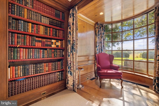 living area featuring wooden walls and wood ceiling