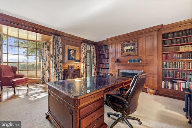 office space featuring light carpet and wood walls