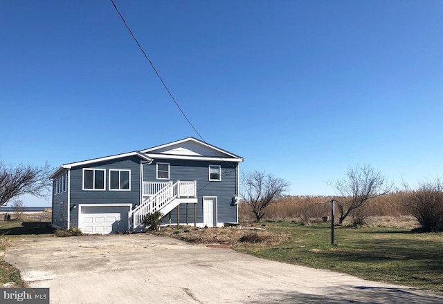 view of front of property with a front lawn and a garage