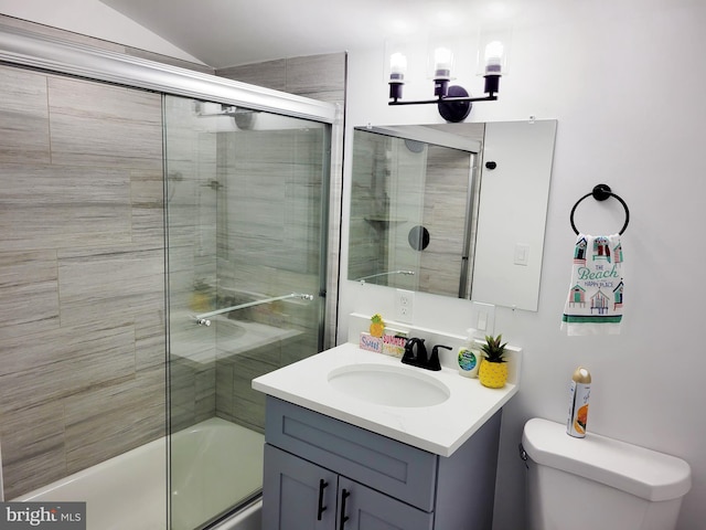 full bathroom featuring enclosed tub / shower combo, toilet, and vanity with extensive cabinet space