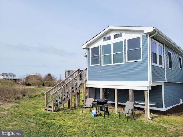 rear view of house with a yard