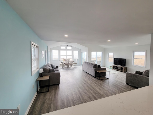 living room featuring ceiling fan and dark hardwood / wood-style floors