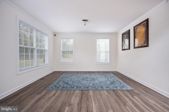 empty room with crown molding and dark hardwood / wood-style floors