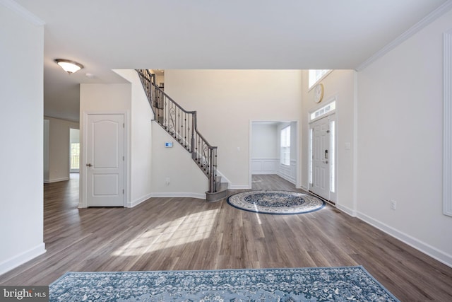 entryway featuring ornamental molding and hardwood / wood-style floors