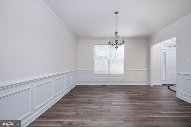 unfurnished dining area featuring crown molding, dark hardwood / wood-style floors, and a notable chandelier