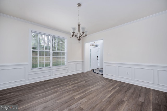 unfurnished dining area with crown molding, a notable chandelier, and dark wood-type flooring