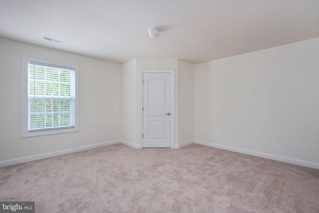 spare room with light carpet