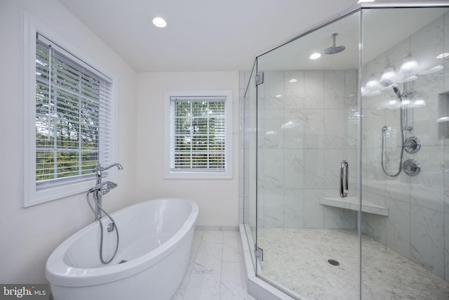 bathroom featuring shower with separate bathtub