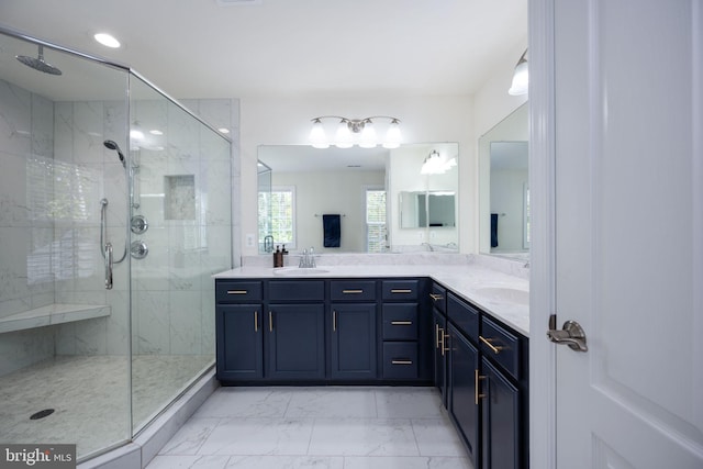 bathroom with vanity and a shower with door