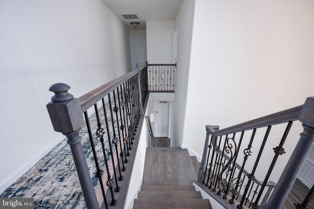 stairs featuring hardwood / wood-style flooring