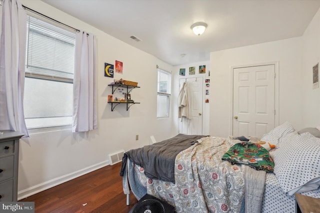 bedroom with dark hardwood / wood-style flooring