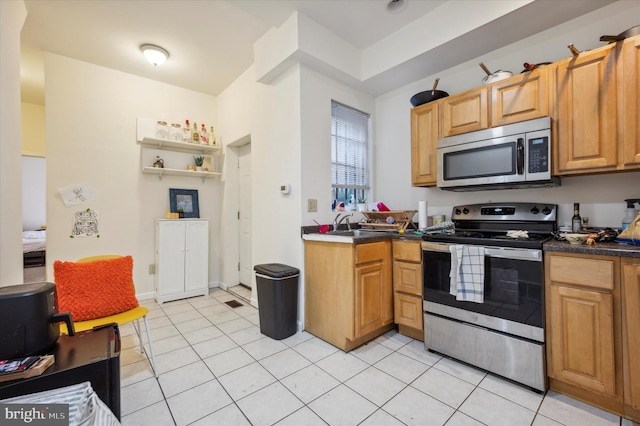 kitchen featuring light tile patterned flooring and stainless steel appliances