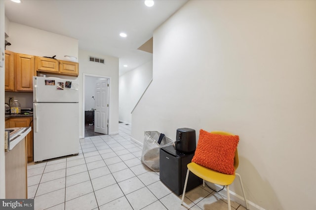 kitchen featuring white refrigerator and light tile patterned flooring