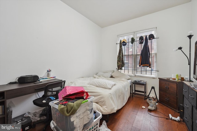 bedroom with dark hardwood / wood-style flooring and vaulted ceiling