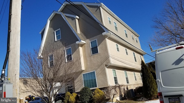 view of side of property featuring central AC