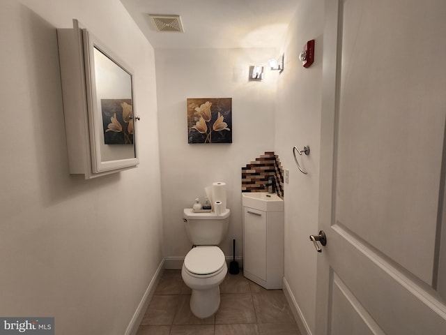 bathroom featuring vanity, tile floors, and toilet