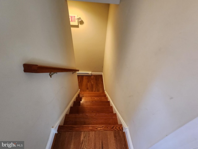 staircase featuring a baseboard radiator and dark wood-type flooring