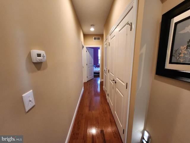 hallway with dark hardwood / wood-style floors