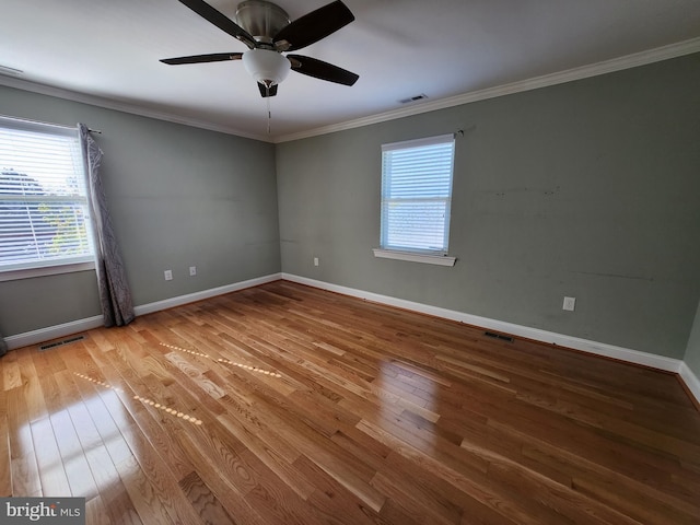 unfurnished room with ceiling fan, crown molding, and light hardwood / wood-style floors