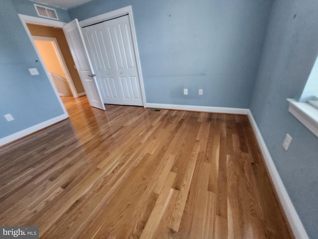 unfurnished bedroom featuring a closet and light hardwood / wood-style flooring