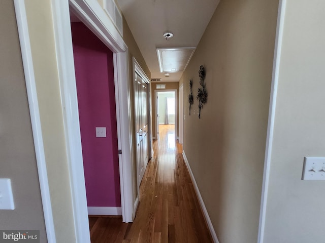 corridor with dark hardwood / wood-style flooring