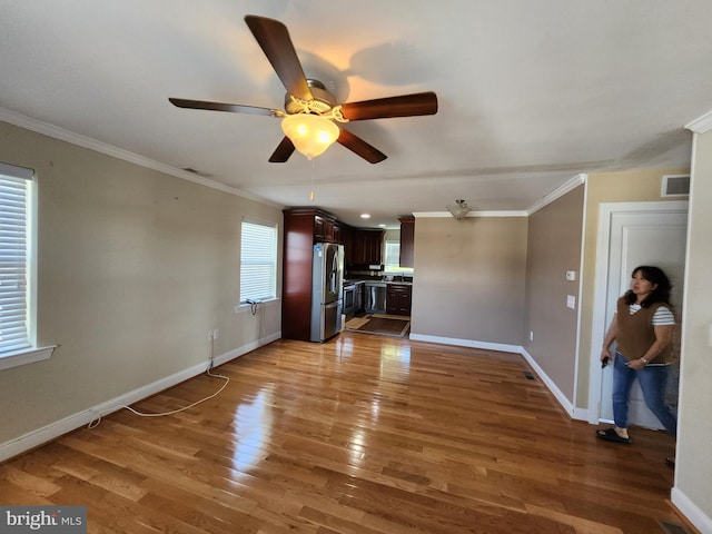 unfurnished living room featuring crown molding, ceiling fan, and hardwood / wood-style flooring