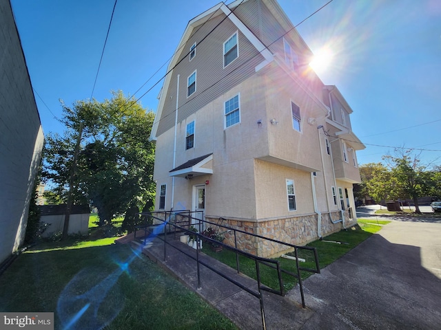 view of side of home featuring a yard