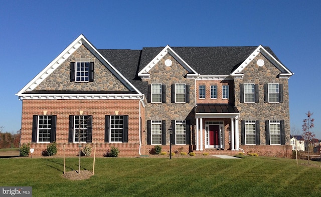 colonial inspired home with a front lawn