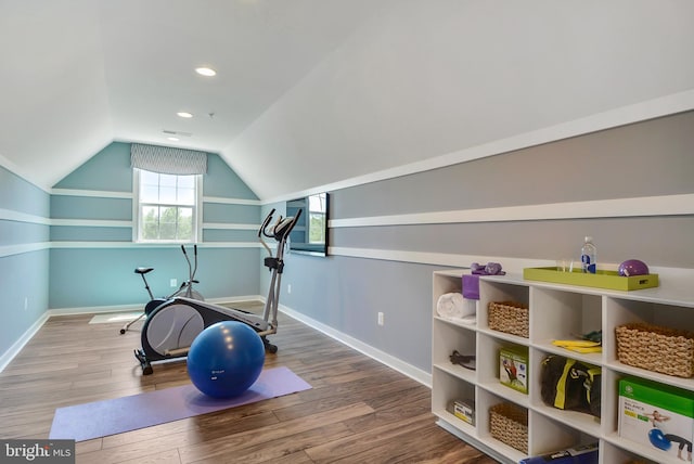 workout area featuring lofted ceiling and hardwood / wood-style floors