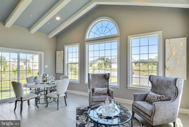 interior space with high vaulted ceiling, beam ceiling, and light tile flooring