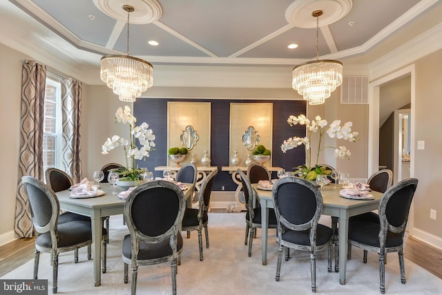 dining room with crown molding, an inviting chandelier, and light hardwood / wood-style flooring