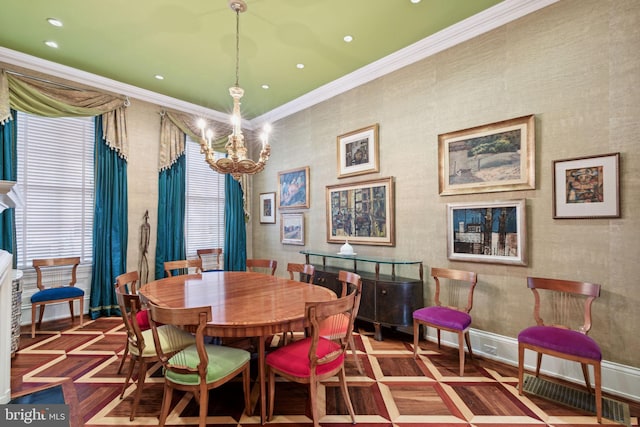 dining room with dark parquet floors, a chandelier, and crown molding