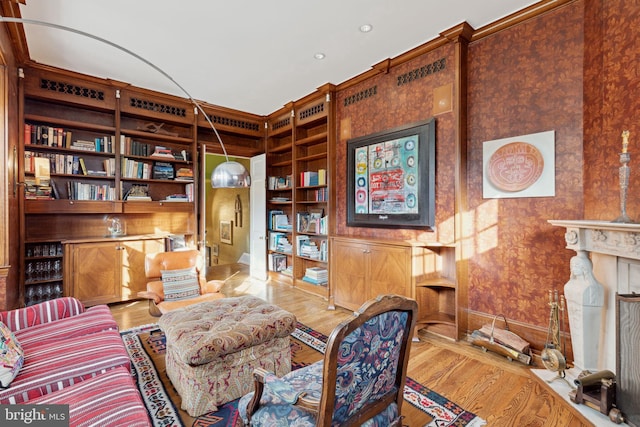 living area with built in shelves and light wood-type flooring