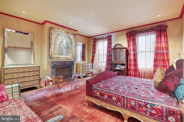 bedroom featuring hardwood / wood-style flooring and crown molding