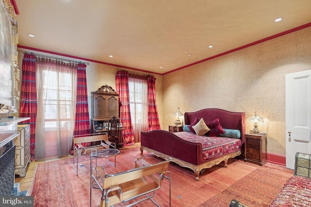 bedroom featuring crown molding and light hardwood / wood-style floors